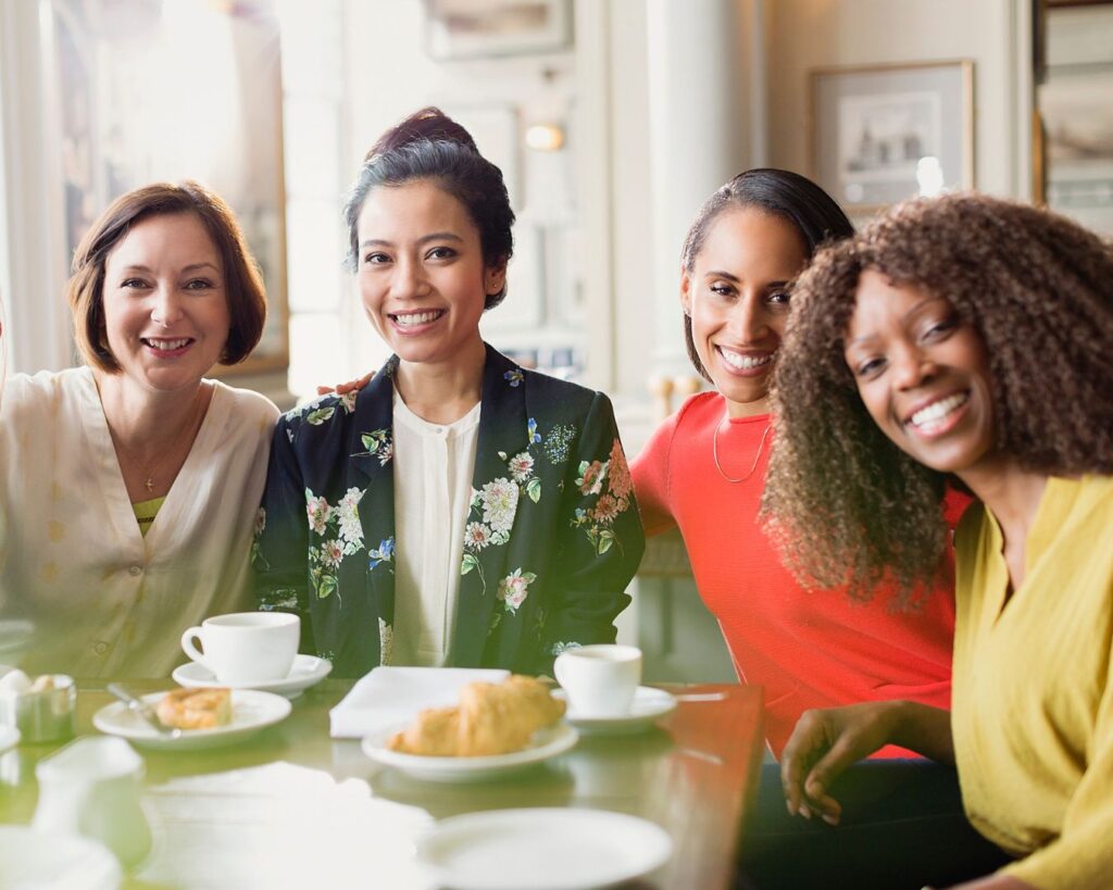 Diverse group of professional women gathered together, illustrating midlife leadership boundaries, sustainable leadership, and support during menopause.