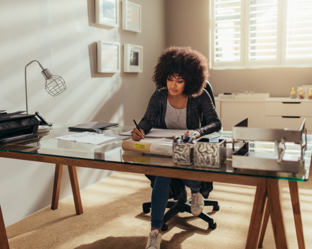 Midlife professional woman focused at her desk, illustrating how to protect peak earning years during menopause through career strategy and financial confidence.